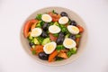 Salad with quail eggs tomato cucumber olive greens. Mix of fresh vegetables, Mediterranean cuisine. Plate with egg and vegetable Royalty Free Stock Photo