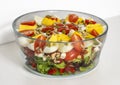 Salad with quartered egg, tomato, lettuce, and grains in a bowl