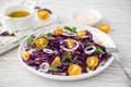 salad of red cabbage, yellow cherry tomatoes and onions