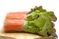 Salad roll in noodle with carrot and fresh vegetables on wooden plate and white background Royalty Free Stock Photo