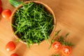 Salad with rugula and cherry tomatoes on wooden table. Royalty Free Stock Photo