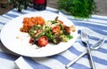 plate of salad with salmon, crushed cashew nuts, cherry tomatoes