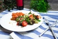 Plate of salad with salmon, crushed cashew nuts