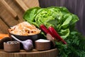 Salad of sauerkraut with carrots on the plate , fresh vegetables and seasonings around