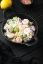 Salad with shrimp, avocado, tomatoes and mayonnaise on the lettuce , with sauce apple and grape, on black wooden table , with copy