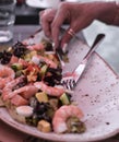 Salad with shrimp, mid-black salad, shrimp omalate female hand