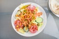 salad of shrimps, tomatoes, cucumbers and lettuce with a yogurt sauce on a white plate and a gray table, high angle view from Royalty Free Stock Photo