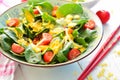 Salad with spinach, onions, tomatoes and a yellow turmeric dressing