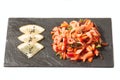 Salad with squid on a black plate with lemon Royalty Free Stock Photo