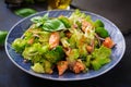 Salad of stewed fish salmon, broccoli, lettuce and dressing.