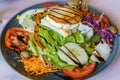 Salad with tomato, cucumber, lettuce, olives, carrots, goat cheese with virgin olive oil and balsamic vinegar. Healthy meal