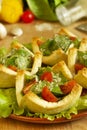Salad with tomatoes and cheese in tartlets