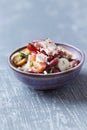 Salad with tuna and cherry tomatoes. Wooden background.