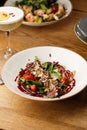 Salad with veal and tomatoes. Beef steak with raw vegetables mix side view. Grilled meat with garnish close-up Royalty Free Stock Photo