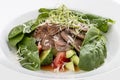 Salad with veal tongue, quinoa and avocado. On white background