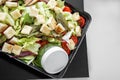 Salad with vegetables and chicken and pesto sauce in lunch box. The concept of food and food delivery Royalty Free Stock Photo