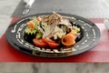 salad of vegetables,lechuga with mayonnaise,sliced meats of ham and jamon beautifully decorated with chopped vegetables on a plate Royalty Free Stock Photo