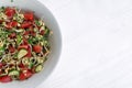 Salad with vegetables and microgreens, sprouts of cereals and green plants of broccoli, tomatoes, cucumbers, oil, salt, pepper in