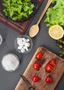 Salad of vegetables with spices. On a wooden surface. Pieces of vegetables, cherry tomatoes, spices, basil