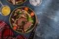 Salad with warm beef with oyster mushrooms, tomatoes and greens.