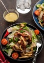 Salad with warm beef with oyster mushrooms, tomatoes and greens.