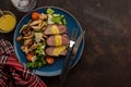 Salad with warm beef with oyster mushrooms, tomatoes and greens.