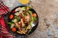 Salad with warm beef with oyster mushrooms, tomatoes and greens.