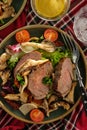 Salad with warm beef with oyster mushrooms, tomatoes and greens.