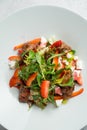 Salad with warm chicken liver, fresh strawberries and vegetables