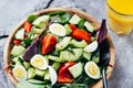 Salad on wooden plate and orange juice Royalty Free Stock Photo