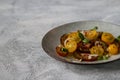 Salad of yellow and black tomatoes on a gray plate, photo with free space.