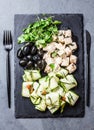 Salad with zucchini, cheese feta, olives and rucola, slate plate Royalty Free Stock Photo