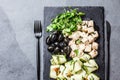 Salad with zucchini, cheese feta, olives and rucola, slate plate Royalty Free Stock Photo