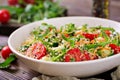 Salads with quinoa, arugula, radish, tomatoes and cucumber Royalty Free Stock Photo