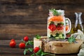 Salads with quinoa, arugula, radish, tomatoes and cucumber in glass Royalty Free Stock Photo