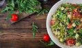 Salads with quinoa, arugula, radish, tomatoes and cucumber