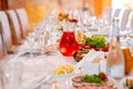 salads, snacks, drinks and glasses on the served festive table.