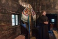 Salaj, Romania-May 16, 2018: Orthodox priest holding a Christian cross, praying in a old wooden church in Transylvania region,