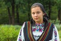 Salaj, Romania-May 15, 2018: outdoor portrait of a young girl wearing traditional Romanian costume