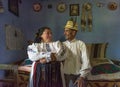 Salaj, Transylvania, Romania-May 14, 2018: old couple, man and wife in traditional Romanian folk costume in their charming house,