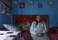 Salaj, Transylvania, Romania-May 14, 2018: very old woman sitting alone inside her little charming house in countryside