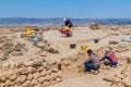 SALALAH, OMAN - FEBRUARY 25, 2017: Workers and archeologists at Sumhuram Archaeological Park with ruins of ancient town Khor Rori
