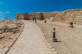 SALALAH, OMAN - FEBRUARY 25, 2017: Workers and archeologists at Sumhuram Archaeological Park with ruins of ancient town Khor Rori
