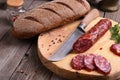 Salami, bread and a knife on the table Royalty Free Stock Photo