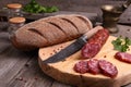 Salami, bread and a knife on the table Royalty Free Stock Photo
