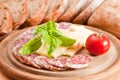 Salami, cheese, bread ciabatta, basil and tomato Royalty Free Stock Photo