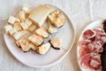 Salami and cheese, traditional italian appetizers on natural light fabric background Royalty Free Stock Photo