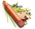 Salami decorated with onion, dill, olive and pie