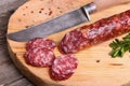 Salami and knife on a cutting board Royalty Free Stock Photo