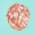 Salami Napoli isolated on blue background. Salami Napoli macro Royalty Free Stock Photo